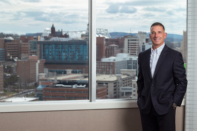 A corporate environmental portrait in the office next to a window with a view