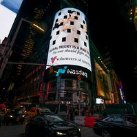 The Volunteers of America campaign photographed by Nir Arieli on Times Square's NASDAQ building, NYC at night
