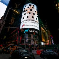 The Volunteers of America campaign photographed by Nir Arieli on Times Square's NASDAQ building, NYC at night