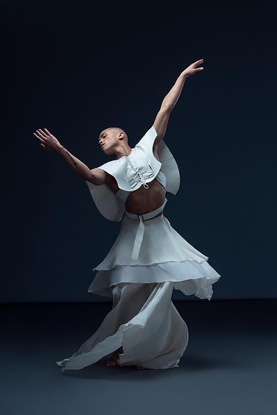 Dancer Travon M. Williams dancing in a white skirt