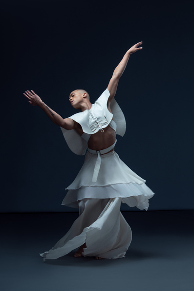 Dancer Travon M. Williams dancing in a white skirt