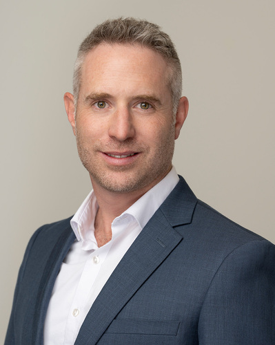 a corporate headshot on a grey background