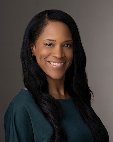 a corporate headshot on a gradient grey background