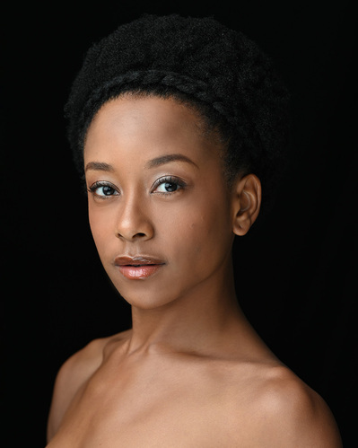 Headshot of a dancer on a black background at the Ailey School