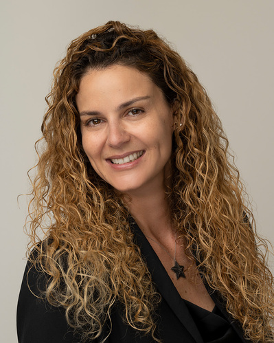 a corporate headshot on a grey background
