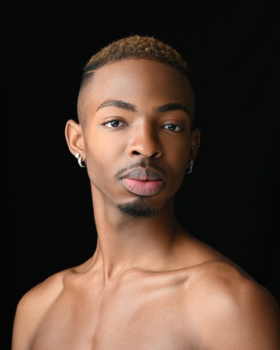 Headshot of a dancer on a black background at the Ailey School