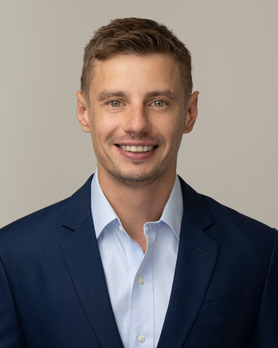 a corporate headshot on a grey background