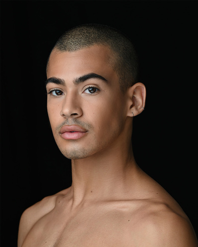 Headshot of a dancer on a black background at the Ailey School