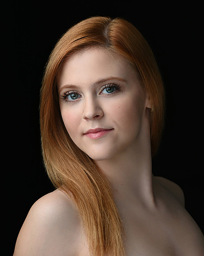 Headshot of a dancer on a black background at the Ailey School