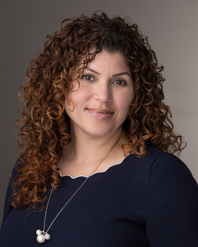 a corporate headshot on a gradient grey background