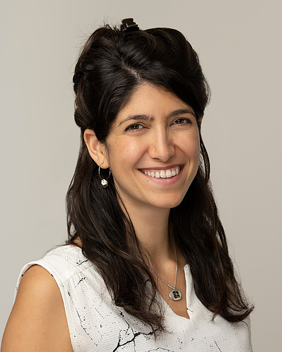 a corporate headshot on a grey background