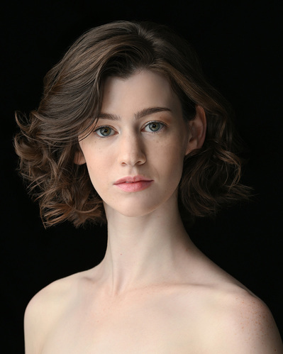 Headshot of a dancer on a black background at the Ailey School