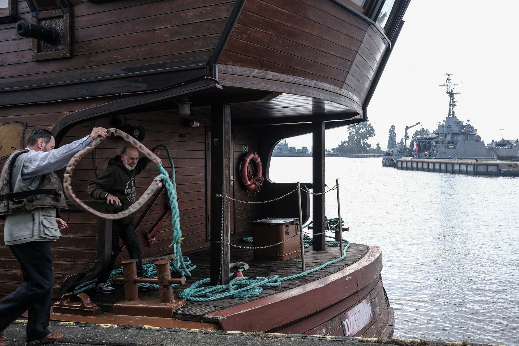 "Roza Weneda", a pirate ship replica, preaparing to for a tourist cruise at Świna rivermouth in Świnoujście, Poland, on 26.09.2023, with Polish Navy vessels in the background.