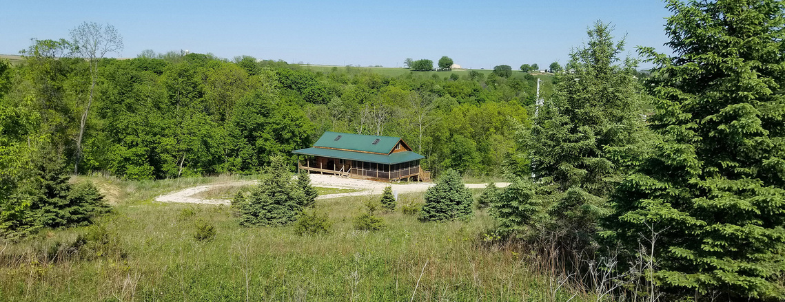 A vacation rental log cabin in Iowa with fireplace and hot tub.