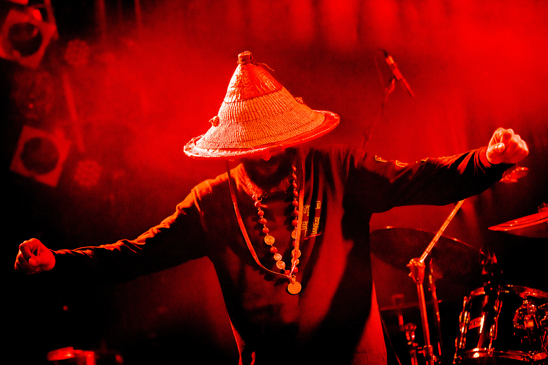 musiciasn dancing on stage in red light