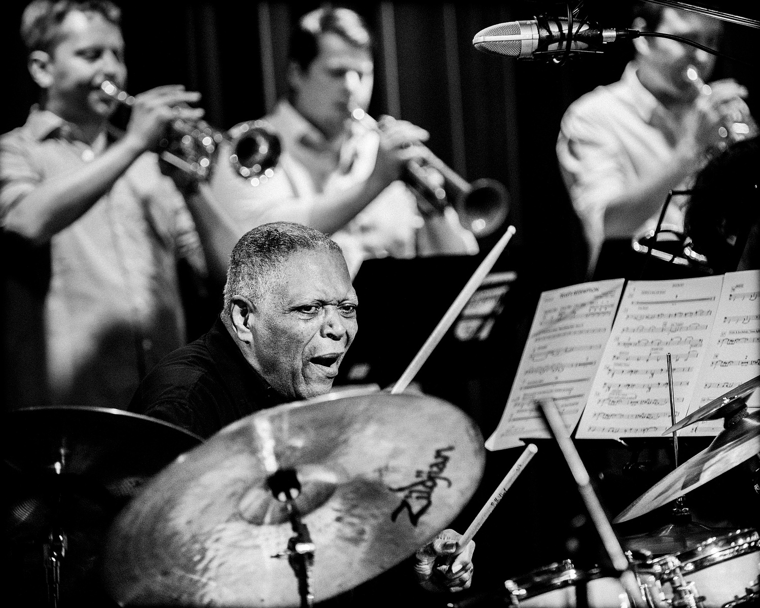 drummer of a big band with 3 trumpeters