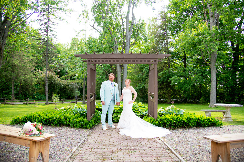 Colour photograph of bride and groom at the front wedding venue at the Strathmere Farmhouse in North Gower.
