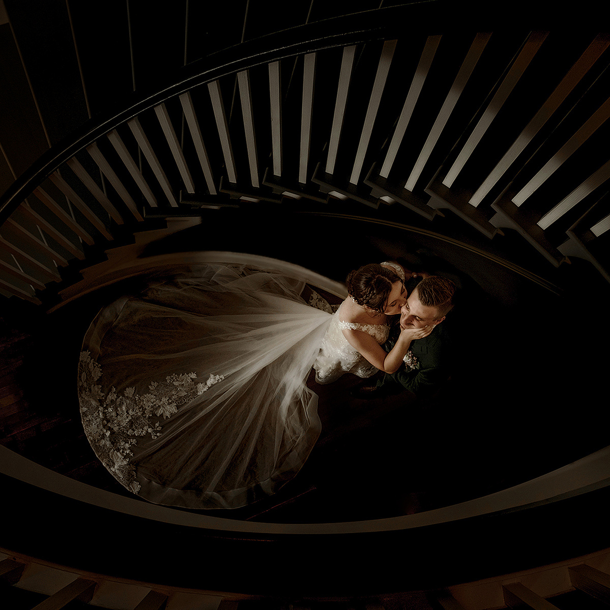 Bride and groom from above a darkened staircase at the Opinicon on their wedding day by Frank Fenn.