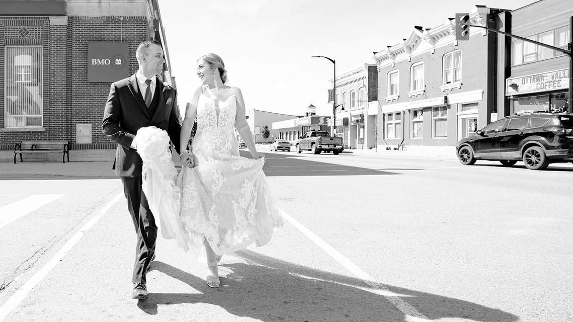Wedding Photographer Renfrew Ontario couple walking down the street in black and white