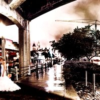This enchanting nighttime photograph captures a romantic moment as a newlywed couple shares an intimate embrace under the shelter of a historic stone bridge in downtown Ottawa. 