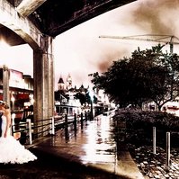 This enchanting nighttime photograph captures a romantic moment as a newlywed couple shares an intimate embrace under the shelter of a historic stone bridge in downtown Ottawa. 