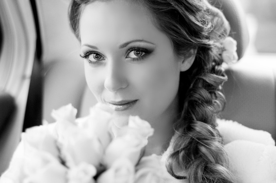The bride is sitting in a exclusive limo scene from Classic Cars in Melbourne. Her eyes are captivating.