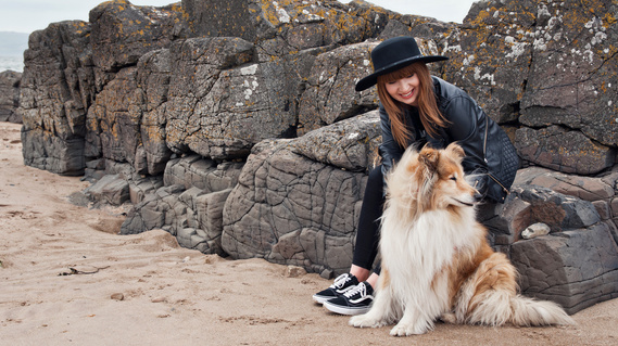 Personal branding photographer Karina Lyburn on a beach with her rough collie dog, by Anne Lyburn