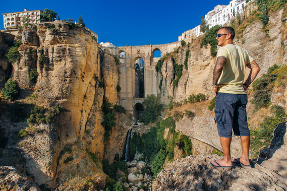Jason Lee viewing the puente nuevo, or new bridge and El Tajo gorge in in Ronda, Spain