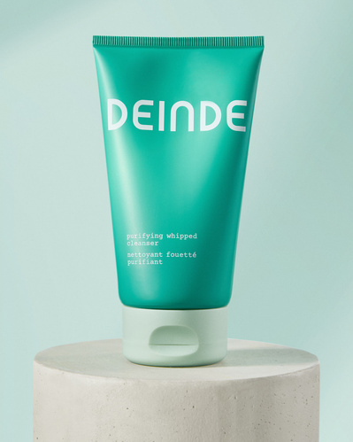 Minimalist product compositions featuring Deinde’s skincare stick and cleanser, placed on concrete pedestals to highlight their sleek packaging and modern design. Photographed by Los Angeles product photographer Alex Kapustin at Rig Studio LA.