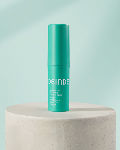 Minimalist product compositions featuring Deinde’s skincare stick and cleanser, placed on concrete pedestals to highlight their sleek packaging and modern design. Photographed by Los Angeles product photographer Alex Kapustin at Rig Studio LA.