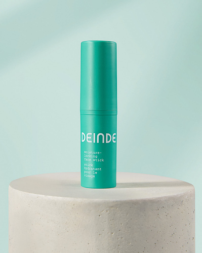 Minimalist product compositions featuring Deinde’s skincare stick and cleanser, placed on concrete pedestals to highlight their sleek packaging and modern design. Photographed by Los Angeles product photographer Alex Kapustin at Rig Studio LA.