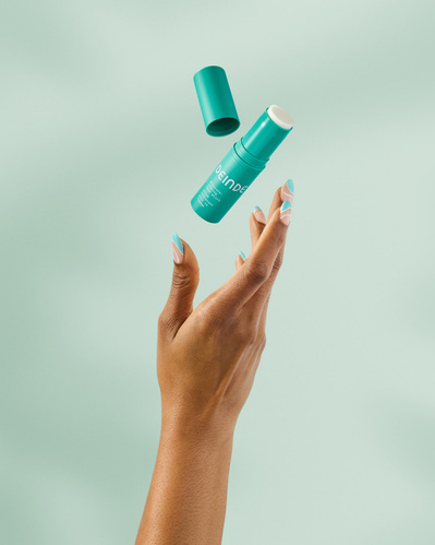 A dynamic skincare shot capturing a Deinde skincare stick mid-air, highlighting effortless hydration and lightweight application. Photographed by Los Angeles product photographer Alex Kapustin at Rig Studio LA.