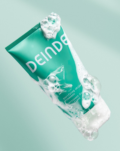 A crisp, high-impact beauty shot showcasing Deinde cleanser with foamy bubbles, emphasizing a deep-cleansing experience. Photographed by Los Angeles product photographer Alex Kapustin at Rig Studio LA.
