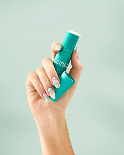A trio of lifestyle product shots showcasing Deinde skincare in hand, highlighting user interaction and product functionality. Photographed by Los Angeles product photographer Alex Kapustin at Rig Studio LA.