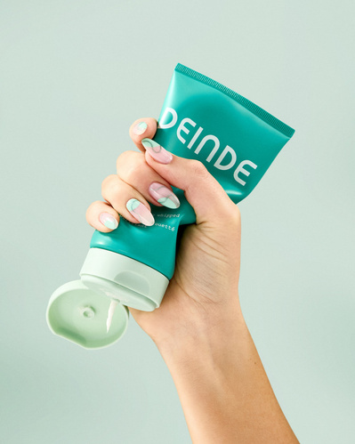 A trio of lifestyle product shots showcasing Deinde skincare in hand, highlighting user interaction and product functionality. Photographed by Los Angeles product photographer Alex Kapustin at Rig Studio LA.