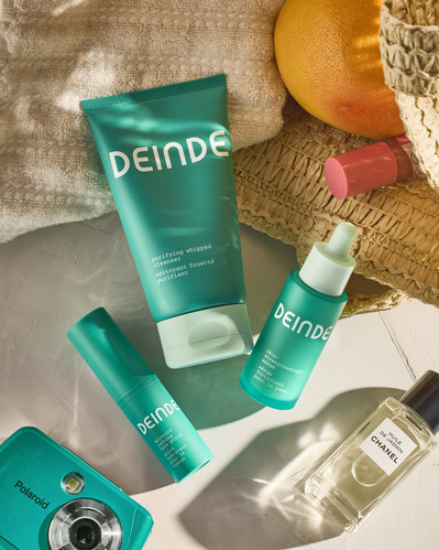 A warm-toned lifestyle shot featuring Deinde skincare alongside soft textures and fresh accessories, evoking a self-care moment. Photographed by Los Angeles product photographer Alex Kapustin at Rig Studio LA