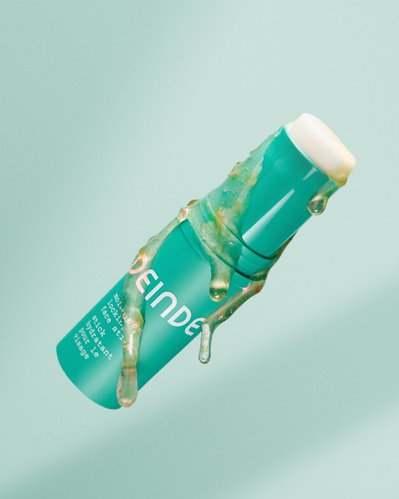 A dynamic product shot of Deinde’s moisture-locking face stick with grapefruit extract dripping, emphasizing hydration and nourishment. Photographed by Los Angeles product photographer Alex Kapustin at Rig Studio LA.