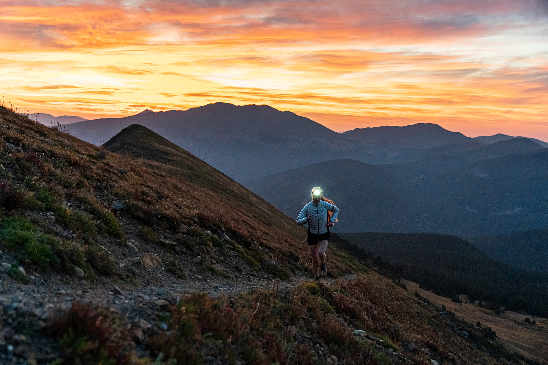 Grace Staberg trail running at sunrise in Breckenridge, Colorado
