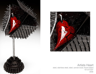 A steel sculpture of a box with nails pointed out with a carved wooden heart inside