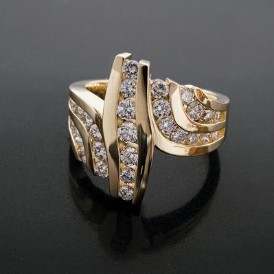 Discover the beauty of a Yellow Gold Wave Channel Set Diamond Ring with a high polish finish. Featuring sparkling diamonds set in a flowing wave design, this ring offers timeless elegance.