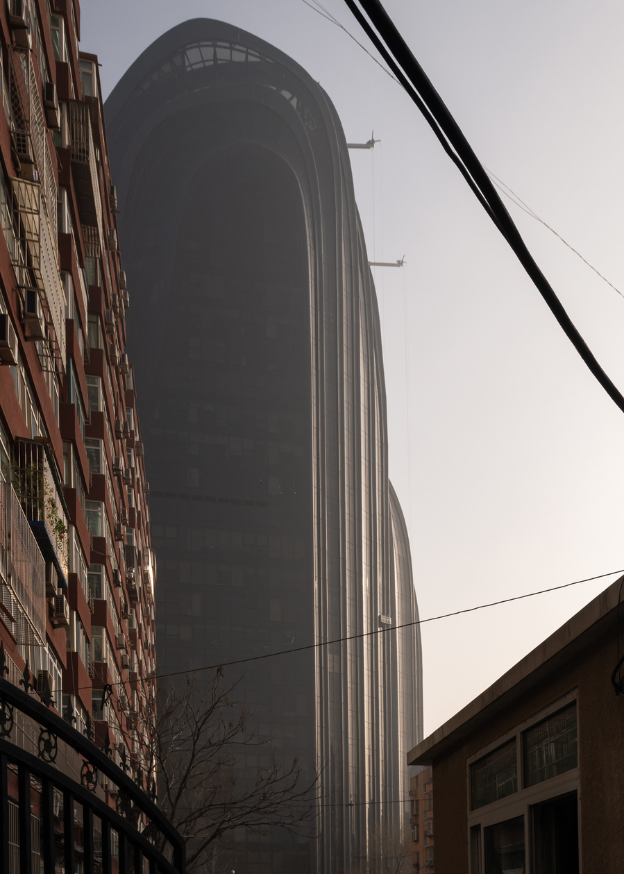 MAD Architects Beijing China Chaoyang Park Plaza. Canadian architectural photographer Adrian Ozimek photographs the exterior of this project at sunrise.Inspired by traditional Chinese landscape paintings