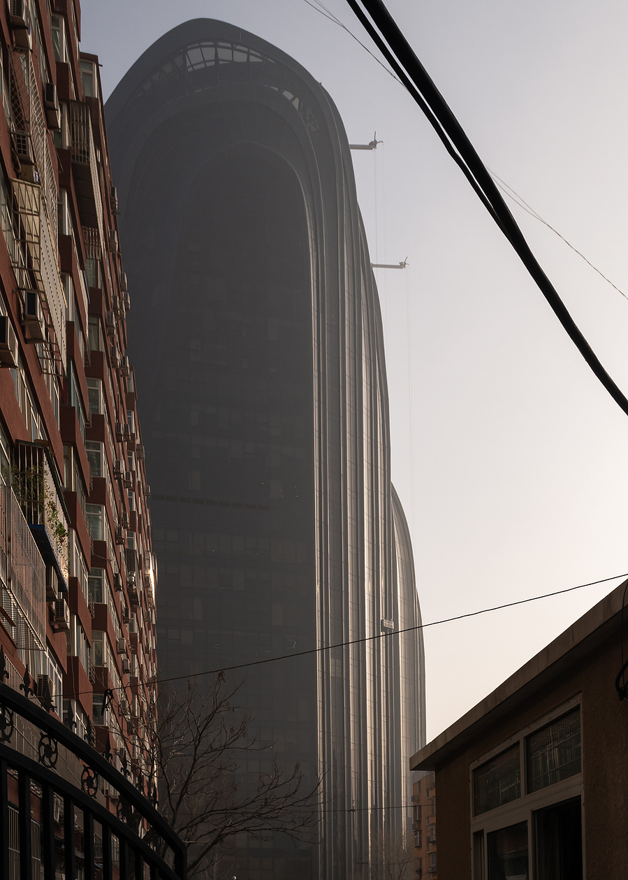 MAD Architects Beijing China Chaoyang Park Plaza. Canadian architectural photographer Adrian Ozimek photographs the exterior of this project at sunrise.Inspired by traditional Chinese landscape paintings