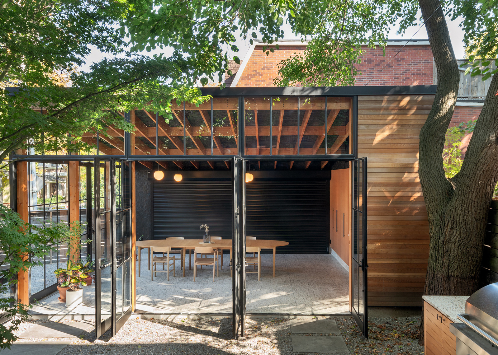 This  small structure re-imagines the detached laneway garage, (often an under-utilized storage space), and makes it into a true extension of the home. The 'Garage Gem' strikes a balance between precious and utilitarian to support a wide range of 