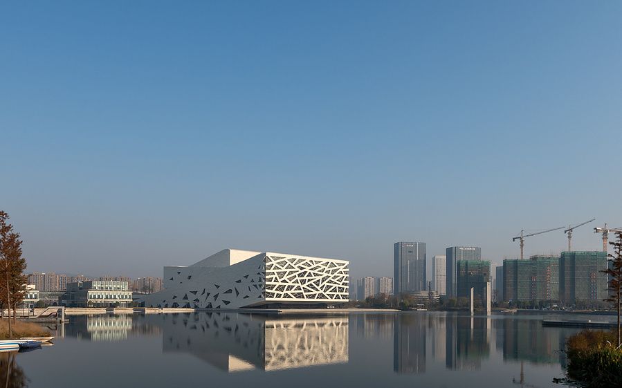 Henning Larson Hanzhou Opera House architectural design in China. Adrian Ozimek architectural photographer captures this project in it's urban context. Canadian architecture and interior photographer