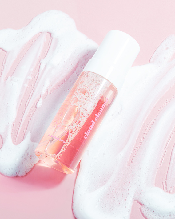JB Lashes Pro Cloud Cleanse Foaming Wash on pink background flat lay with foam and bubbles product photography prop styling by photographer stylist Becca M los angeles