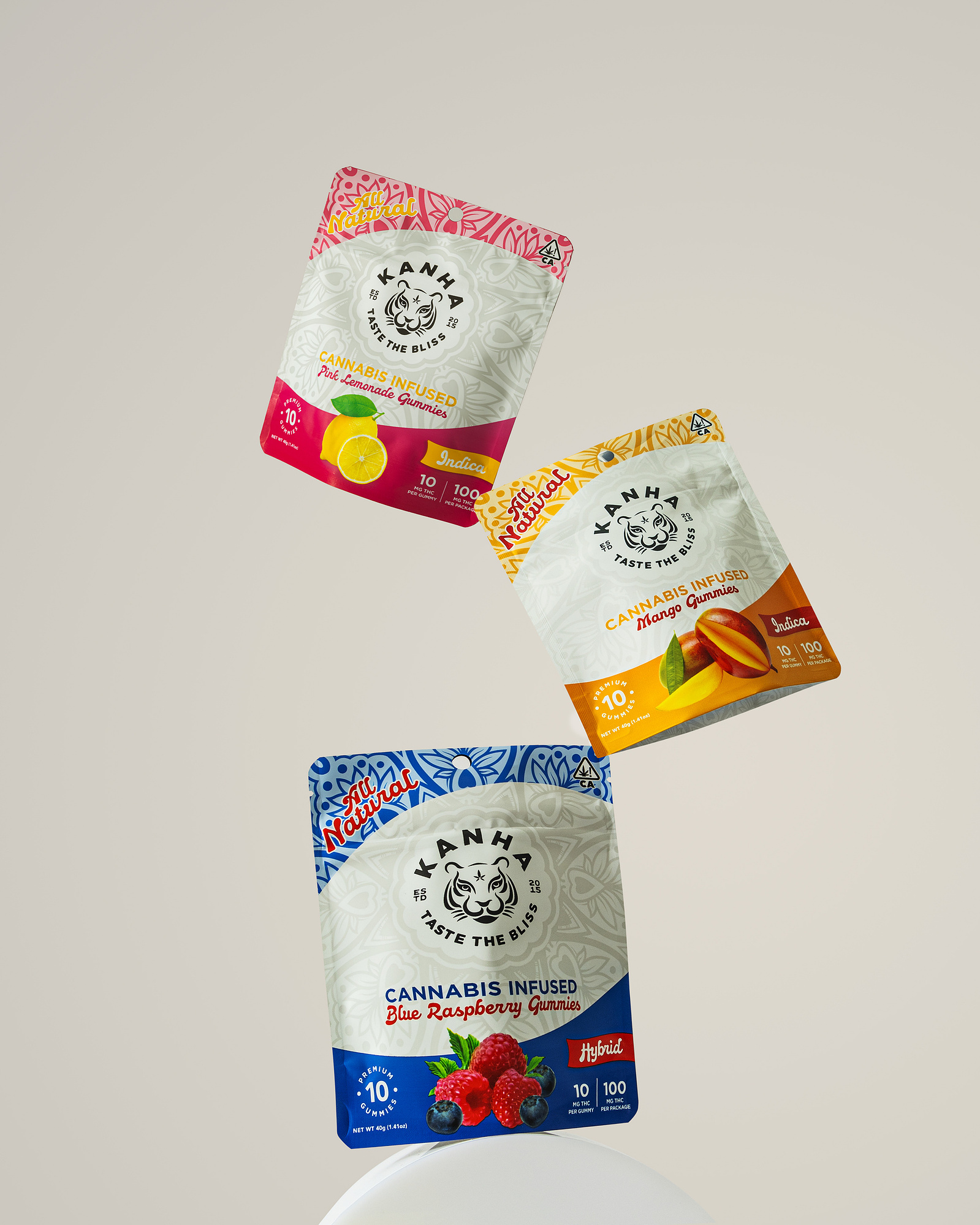 Packaging photography of product bags balanced on a clean neutral backdrop hero angle of three bags stacked on each other.