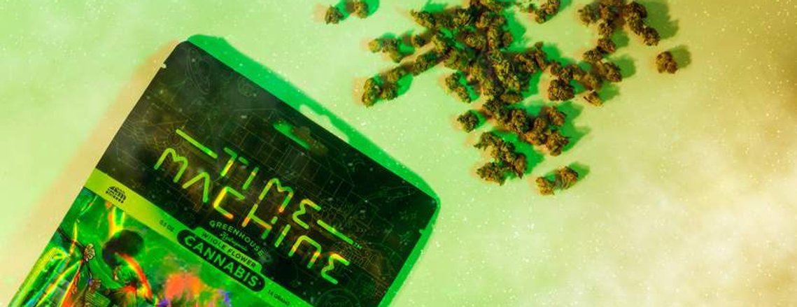 Time Machine Cannabis brand photography of branded various sized packaging with illustrations on celestial space background with product spilled out in the middle.