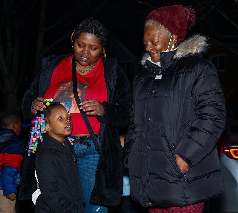 Britney Hardwick's mother, right, her sister, left, and her five-year-old daughter stand outside the house where Britney was killed on December 16, 2020.