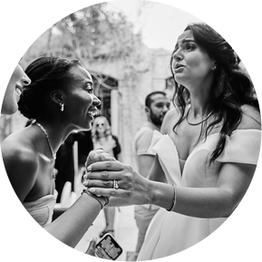 Emotional Black and white photograph, a bride in tears of joy with her friends.