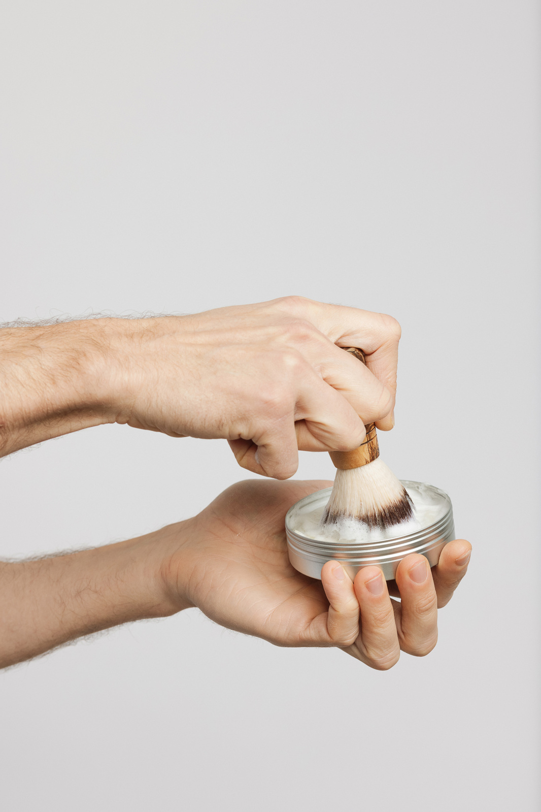 hands holding shaving cream